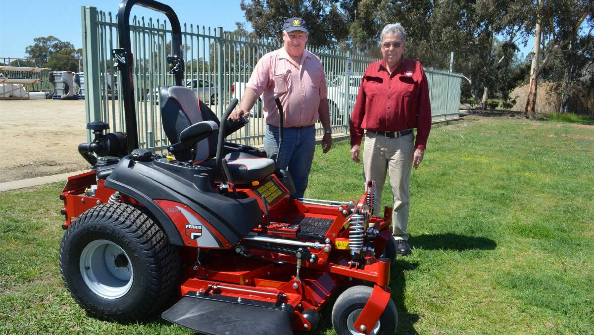 Forbes Deputy Mayor Graeme Miller with his new Ferris ride-on lawn mower, purchased from Frank Spice Auto, Forbes, and business owner Ron Spice.