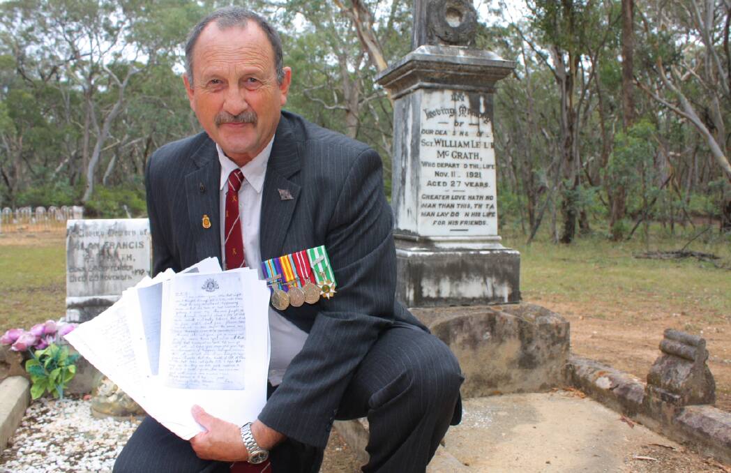 Vietnam veteran David Nelson at the Hargraves Cemetery grave of Sergeant Les McGrath, with copies of the letters written to his grandmother from the thick of the fighting by McGrath during the First World War.