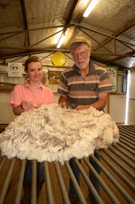 John Ive with his daughter Carolynn proudly display a 4.7kg skirted fleece measuring 14.5 microns grown on their Yass Valley property. 