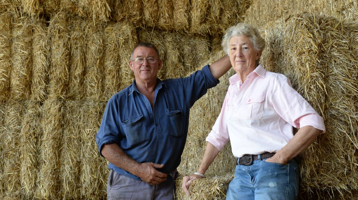 Greg and Trish Kiddle, Coolah Hay and Steel, Coolah, with barley straw bales.