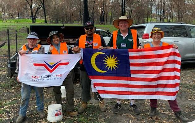 Malaysian BlazeAid volunteers help farmers repair fences in bushfire affected regions. BlazeAid founder Kevin Butler (second from right) said he was thrilled with the changes to the backpacker visa regulations. Photo supplied by BlazeAid. 