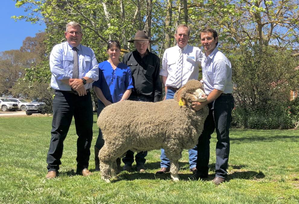 The top ram with Mark Taylor, Schute Bell Badgery Lumby, purchasers, Jodi and Peter Hansch, Weasel Plains Merino Stud, Bothwell, Tasmania, auctioneer, Paul Dooley and stud principal, George Henderson, Grogansworth, Bowning. 
