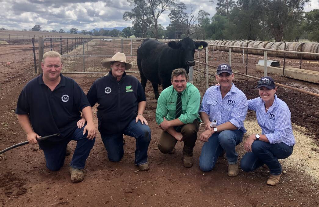 The top-priced heifer, VC Leah P021 with Stuart and Samantha Moeck, Valley Creek Simmentals, Nutrien autioneer Tim Woodham and John and Nicole Hopkins, Wormbete Simmentals. 
