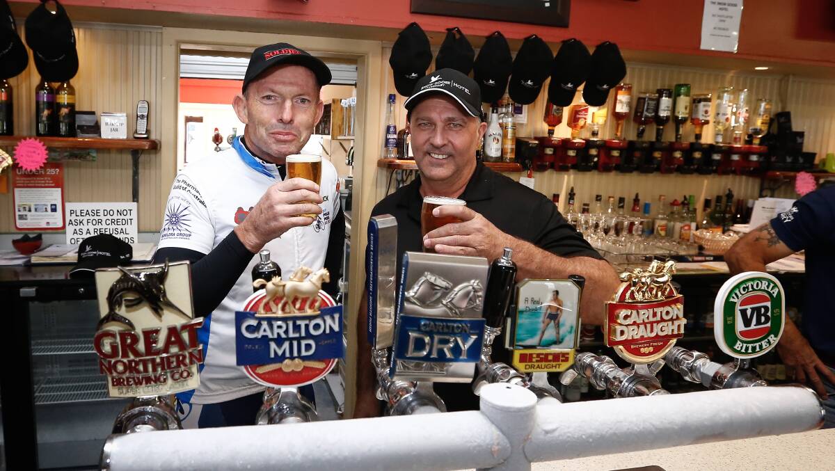 Tony Abbott with Snow Goose hotelier Andrew Smith at the taps at Adaminaby's pub.