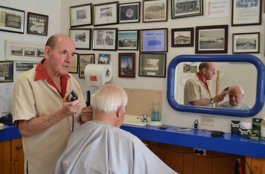 Tony Stewart gets to work on his old mate Terry in his Cooma barber shop. Terry was Tony's 'test mannequin' almost 50 years ago.