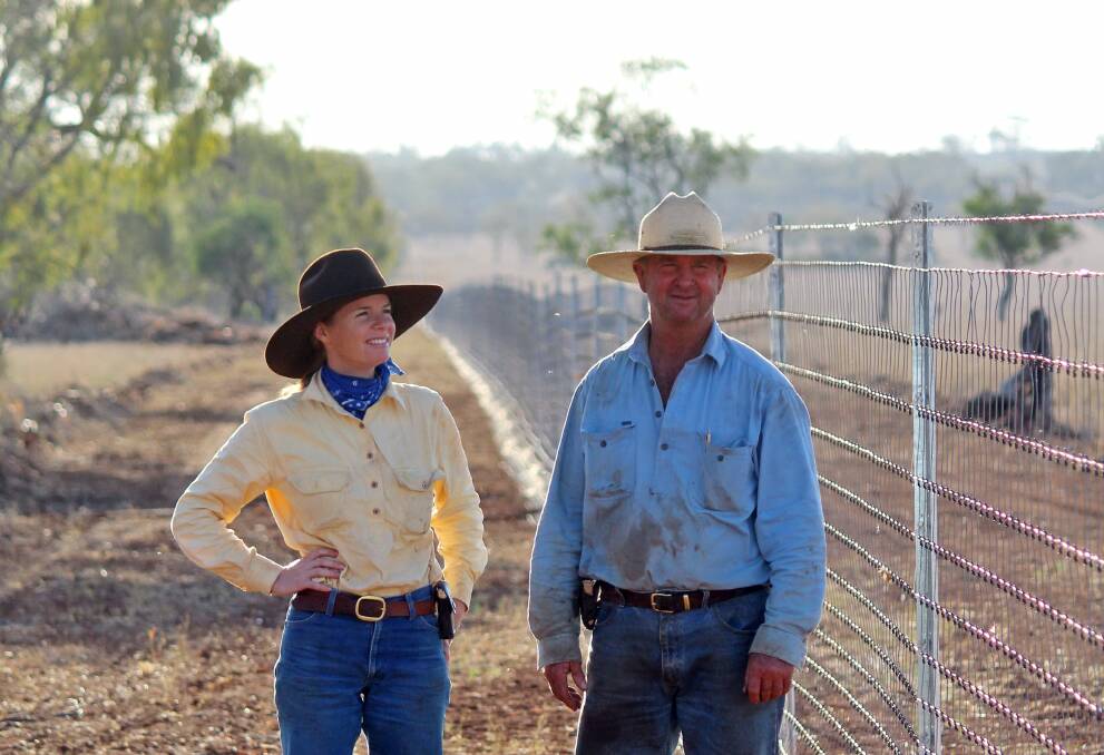 Will Roberts with his daughter Candice beside the huge Morven exclusion fence in southern Queensland.