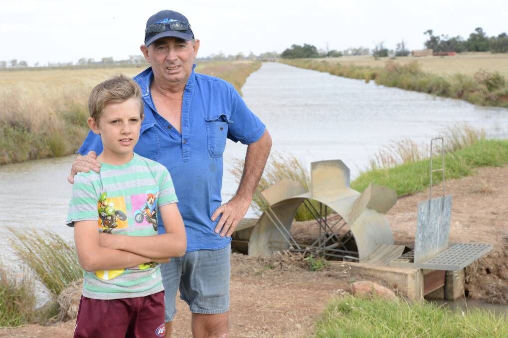 Ricegrower Ian Mason, “Ridgewell”, Finley, pictured on his property with his son Archie, 11, missed out on the chance to buy water in November due to poor communication by Department of Primary Industries Water.