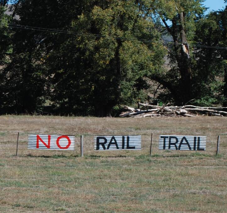 This sign perched in a roadside paddock between Tumut and Batlow sums up farmers' feelings about a proposal to open up an old rail line to walkers and cyclists.