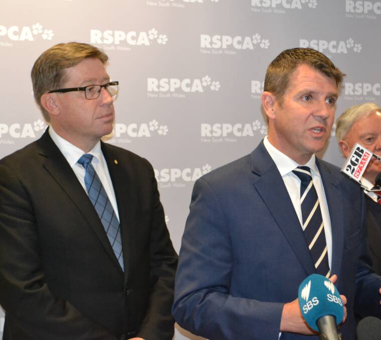 Troy Grant and Mike Baird announce the Greyhound ban. Mr Grant cited the McHugh report into dog racing, saying while Nats members cast free votes he would be “very disappointed” if MPs didn’t back industry shutdown. 