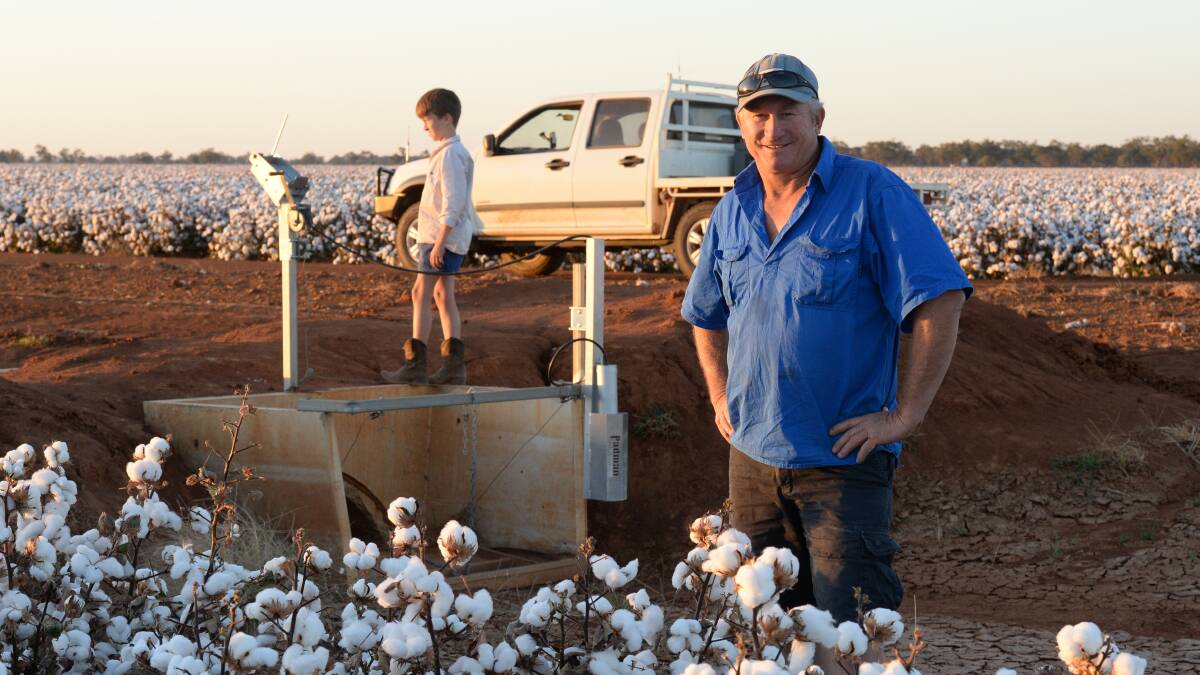 Martin McKinney on a dry, bankless irrigation system with son Lachlan at his Narromine property surveying his 74BRF variety cotton, which has delivered above average yields. 