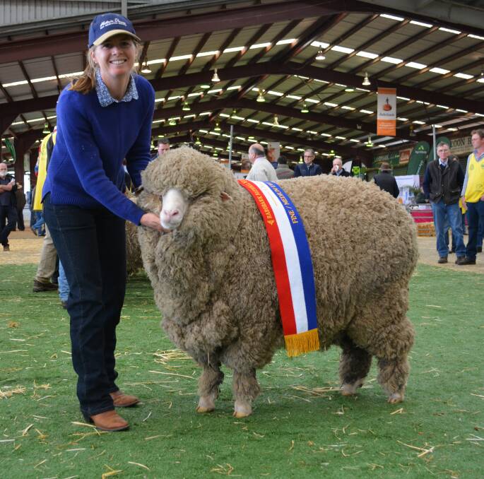 Catherine Perrett, Victoria Downs, Morven, Queensland, with the reserve grand champion ewe. The four-tooth winner also took out the champion fine-medium sash. 
