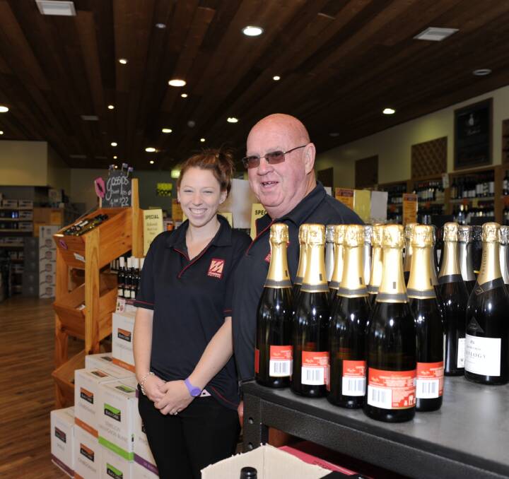 Chambers Cellars, Yass, saleswoman Jaimee Flynn and manager Mick Gaffney are all smiles for customers. Mr Gaffney says customers appreciate the good service. Photo by Paul Melville