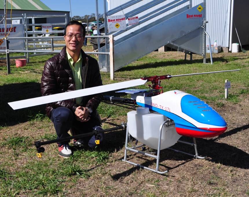 Eagle Brother founder Li Caisheng from China with his remote control helicopter sprayer at AgQuip. He hopes to attract Australian partners.