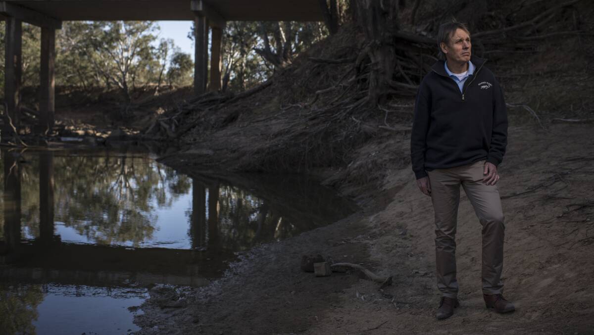 Milton Quigley, Mayor of Warren Shire Council, stands beside the Macquarie River, which ceased to flow beyond the town this week.
