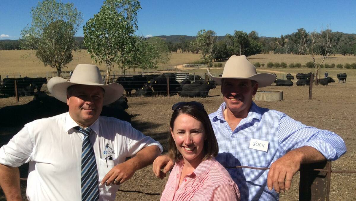 TOTAL CLEARANCE: Auctioneer Michael Glasser, GTSM, Mullengandra, with Natasha and Jock Harbison, Dunoon Angus, Holbrook.