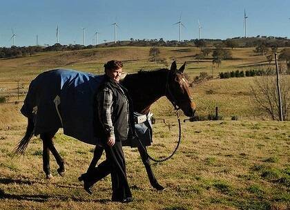 Cullerin Ranges resident and thoroughbred horse trainer Michelle Edwards says her illness may not be caused by the nearby wind farm, but nothing has changed except the arrival of the turbines. Photo: Colleen Petch