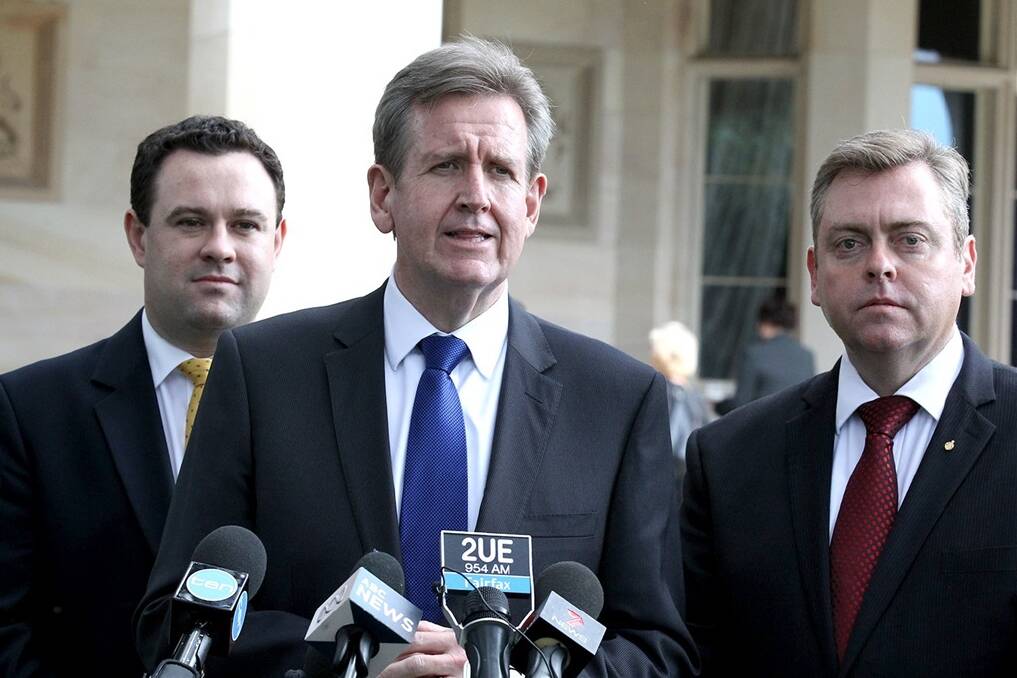 NSW Premier Barry O'Farrell at the swearing in of new Ministers, Anthony Roberts and Stuart Ayres into their new positions.