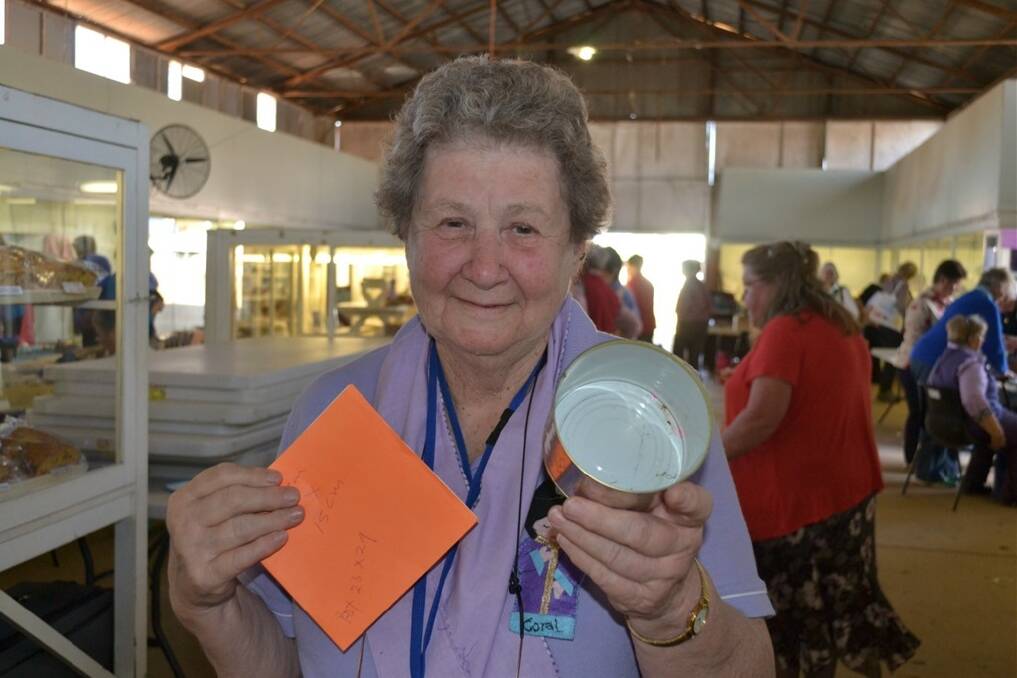 Coral Barber displays the template for the size of the Anzac biscuit and tin for the fruit cake.