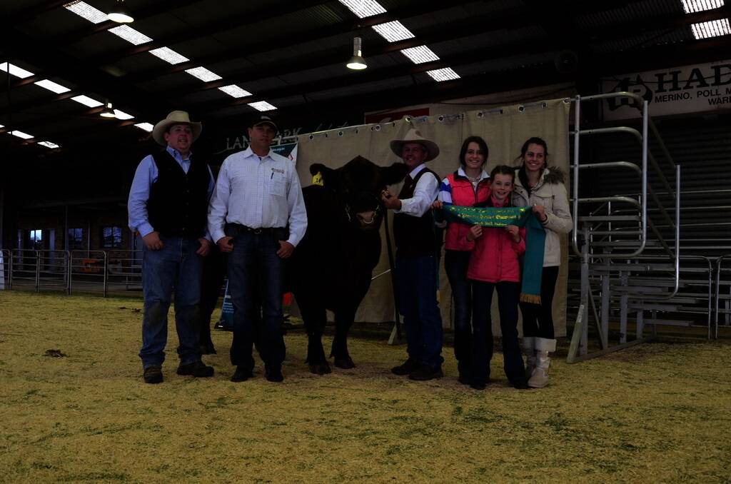 The $13,000 sale-topper and reserve junior champion bull of the 2013 Red Angus National, Dubbo, Bolton Girls Grenade AOBG4, offered by WD Cattle, Holbrook and Bolton Girls stud, Congupna, Victoria. Pictured is co-vendor, Tom Wilding-Davies, Holbrook; buyer Berry Reynolds, IBR stud, Toowoomba, Queensland, and the Bolton team, David Bolton and daughters Aimee, 15; Olivia, 12, and Nicola, 17.