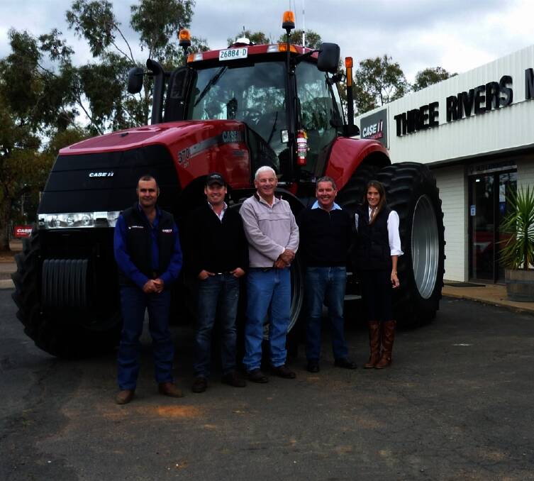 RIGHT: Three Rivers Machinery service manager Ray Watson hands over the new Magnum 370 CVT tractor to  Geoff, Mark, Steve and Eleanor Miller, Trangie.