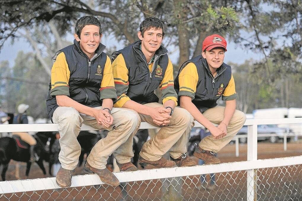 Members of Farrer Memorial Agricultural High School’s champion barrel racing team Hugh and Brad Maxey catch up with school mate, Sam Randle.