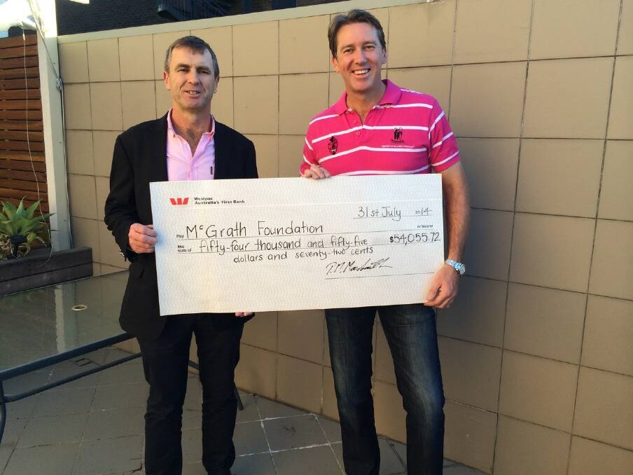 Mill2Mill charity bike ride organiser Pete Mac Smith hands over the cheque to Glenn McGrath, co-founder of the McGrath Foundation.