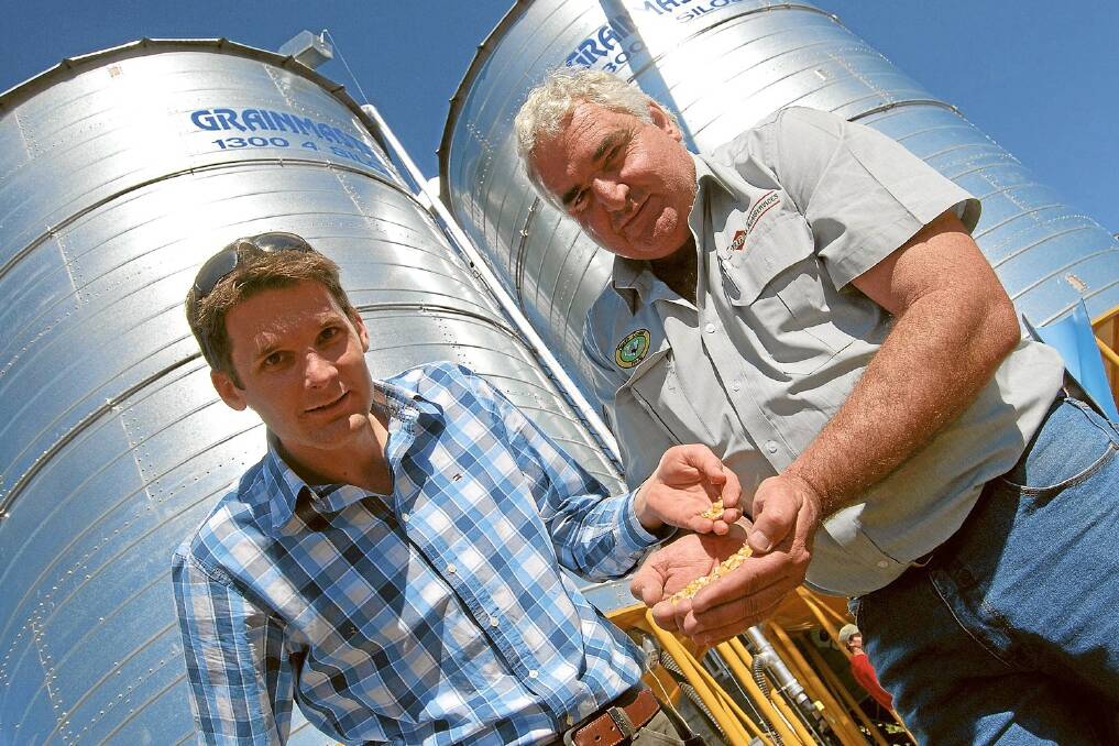 National co-ordinator for GRDC's grains storage extension project Chris Warrick, Victoria, and BGA Agriservices agronomist Mark Carter, Casino with corn in front of Stratheden grower Peter Ludlow's silos.