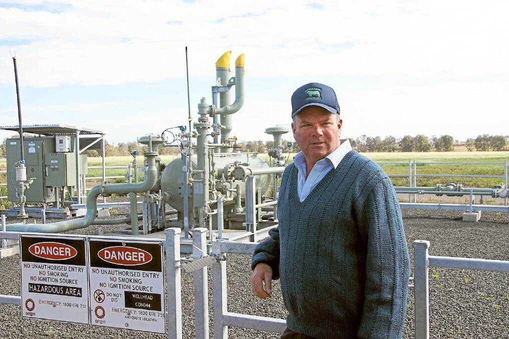 Feedlot owner Simon Drury, Miles, Queensland, pictured with one of 48 wells on his property.