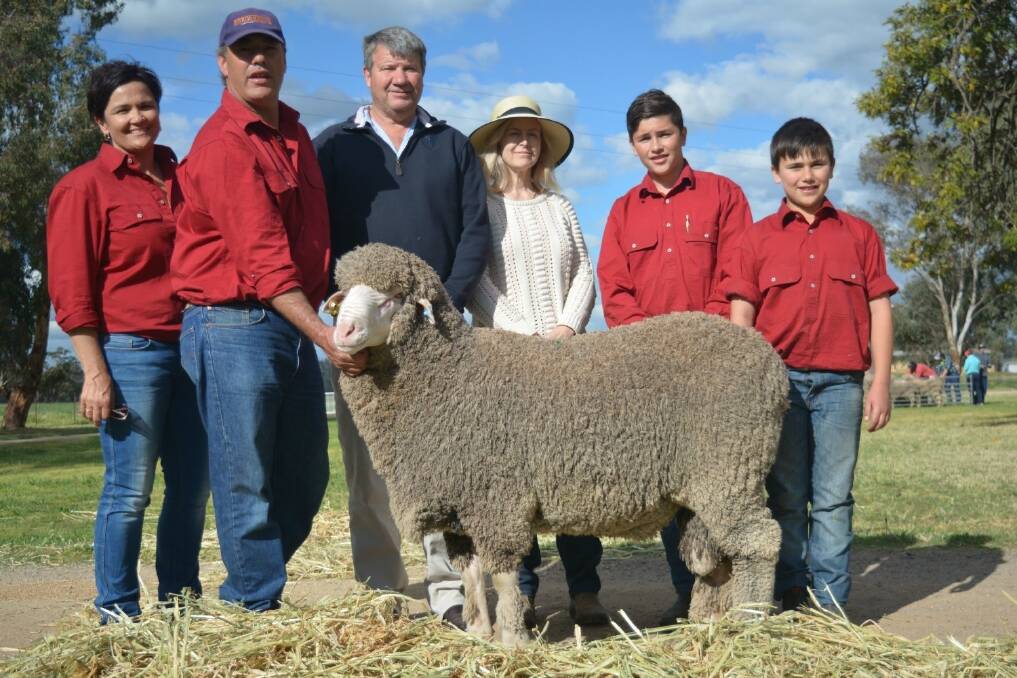 Margot and Glen Rubie of Lachlan Merinos, Forbes, with buyers of the top priced $12,000 ram, Brett and Jenny Woods, Trundle and Mitch and Cam Rubie, Lachlan Merinos