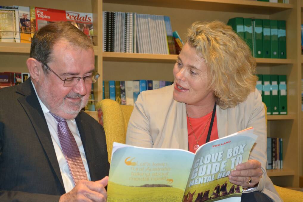 Executive manager of programs and services for the Centre for Rural and Remote Mental Health Trevor Hazell and NSW Farmers president Fiona Simson take a look at the new Glove Box Guide to Mental Health, launched at NSW Farmers head office in St Leonards today.