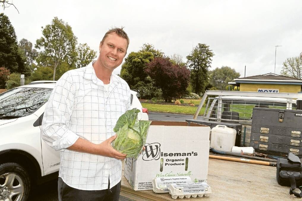 Coleambally farmer Neill Wiseman's son shows some of the produce donated to the Waste Not Want Not Project (WNWNP) .