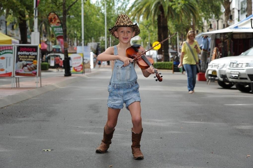 Tamworth boy Cooper Darlington, 7, is one of the youngest buskers on Peel St.