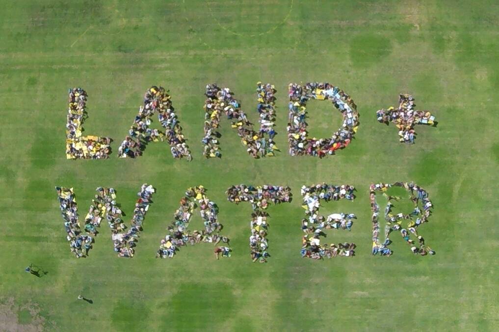 Protesters in Gunnedah formed a human sign yesterday signifying their determination to protect their health, water and land from coal and gas mining.