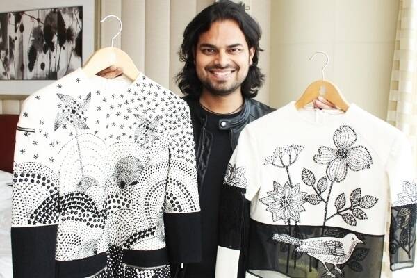 Rahul Mishra with some of his latest designs featuring windmills, sheep, birds and the Australian landscape, inspired by a visit to Merino woolgrowing properties last year.