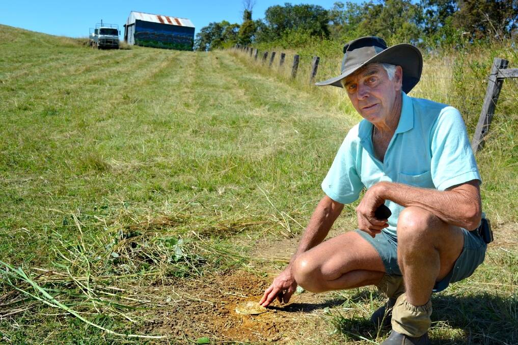 Rob Graham looks at a pipe dug into ground just inside the gateway of his property, which he believes protestors intended to use to padlock themselves to the country. He has cemented it in.