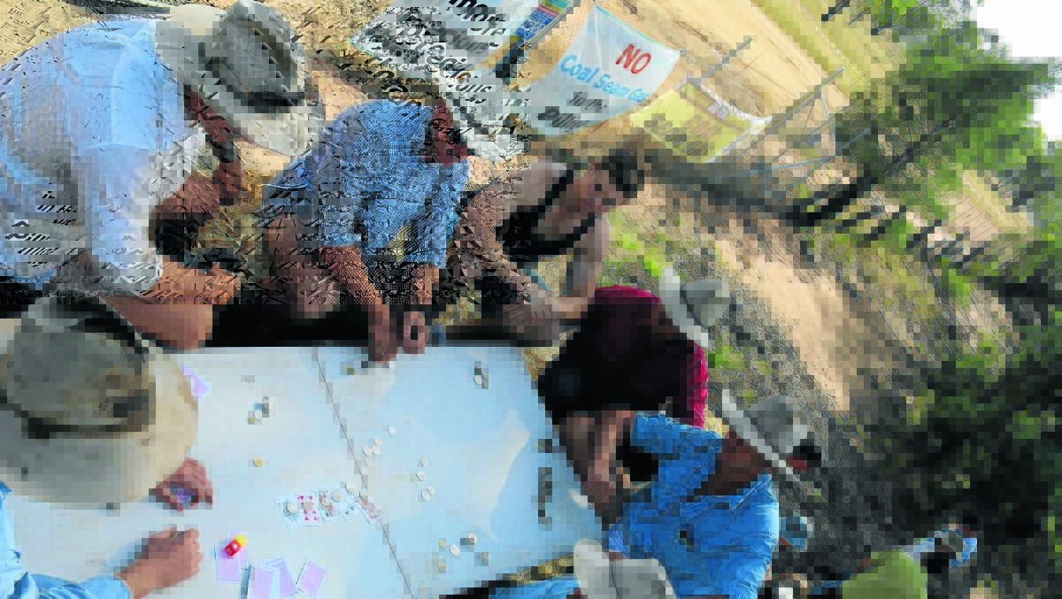 A COOL HAND:  Farmers near Pilliga gamble on 
getting their message across with their hay bale wall stopping access to a Santos CSG water treatment plant. Photo credit: Dan Lanzini