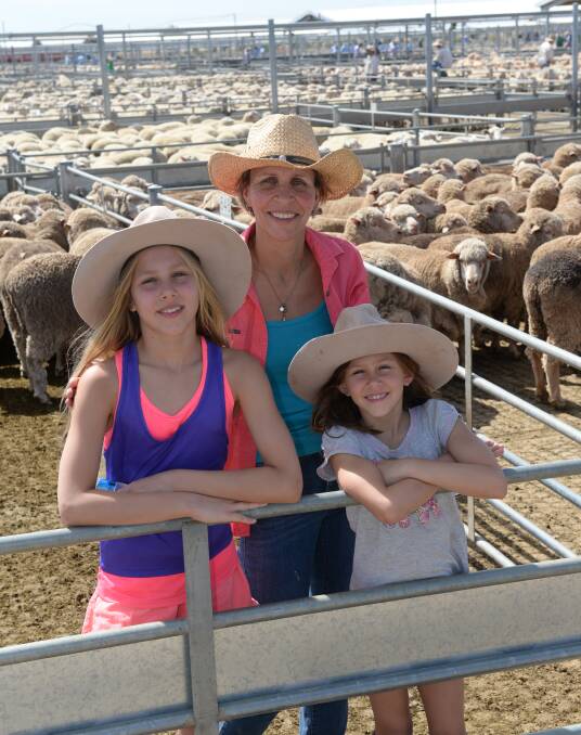 Gwendolyn Hopkins with her daughters, Nadia, 11, and Sasha, 8, "Worrongorrah", Condobolin, checking out the market at the Forbes prime lamb sale last week.  