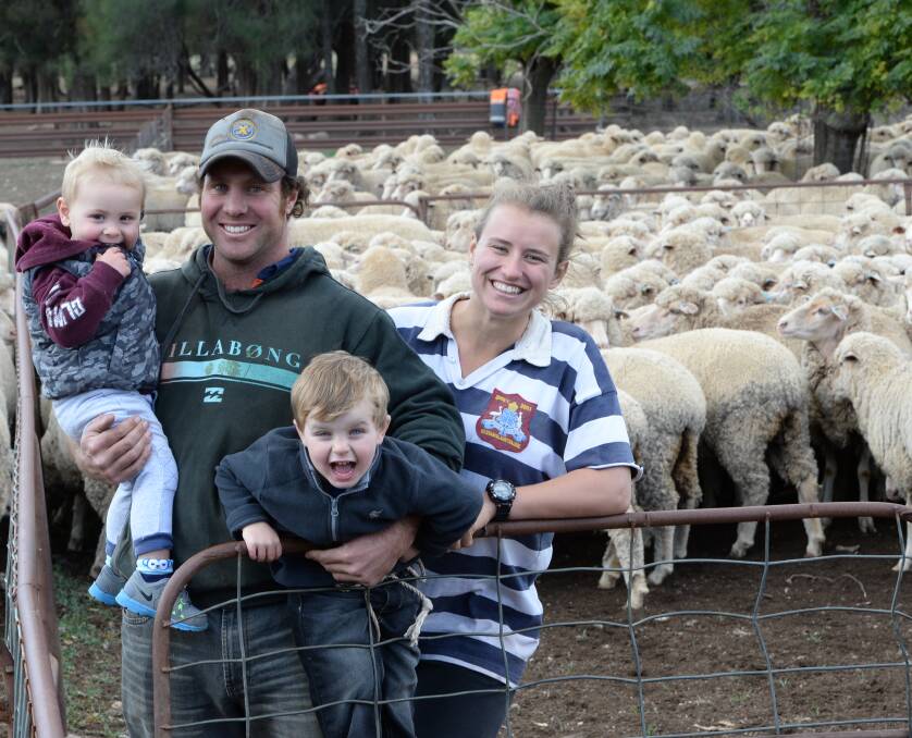 Clint Ridley, "Kookaburragong", Condobolin, with his sons, Reef, 18 months, Huxley, 3, and his partner, Sarah Ostenfeld, Condobolin, in the yards, having mustered 2015-drop maiden Merino ewes. Photo by Rachael Webb