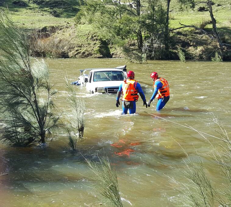 CLOSE CALL: Two people had a lucky escape after their car was swept away by floodwaters.