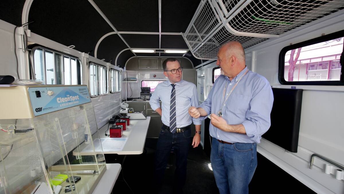 NSW Agriculture Minister Adam Marshall with Department of Primary Industries research officer Ian Marsh inside the mobile molecular biology laboratory - the only one of its kind in Australia. Photo: NSW DPI