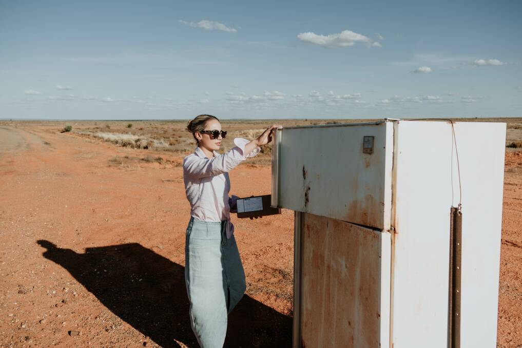 Lucy Gale from Little Ls Ceramics delivering a local ceramic order to her neighbour's fridge postbox in the outback. Picture by Bella Gale Collective 