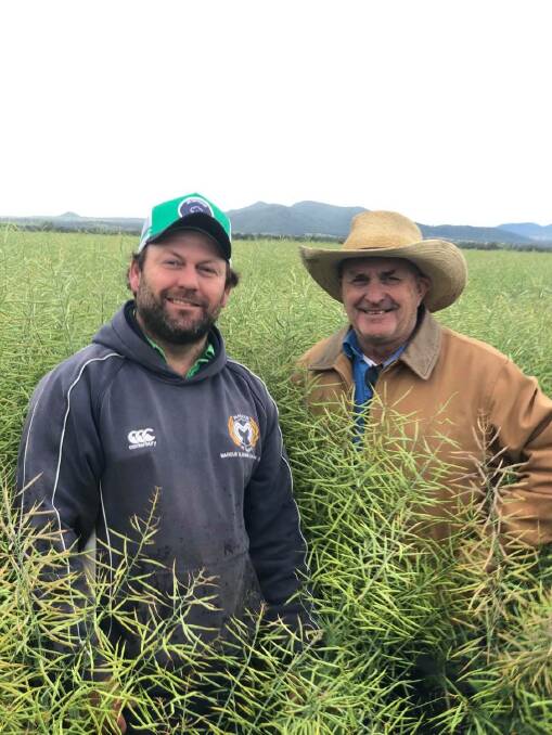 Graeme Norman who runs Norman Pastoral Company and his son Alex with their canola crop at Kibah on the Liverpool Plains. Photo: Samantha Townsend