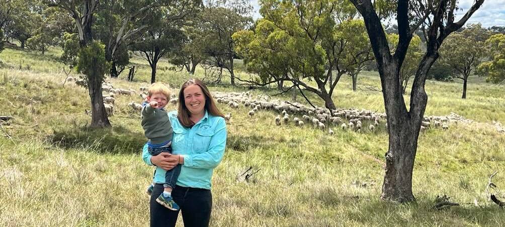 Kristen Hegarty, with her son Jim, 2, and Merino ewes with first-cross lambs run at Belvedere, Cassilis. 
