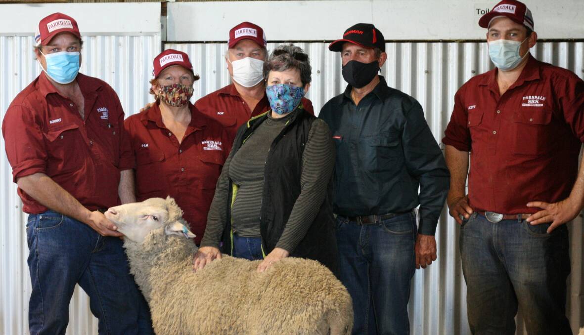 Robert, Pam and Don Mudford with purchasers Carol and Graham Green, Cobar, and Scott Mudford, with the short-tail Merino ram, Parkdale 200076, which sold for the second-top price of $5200. 
