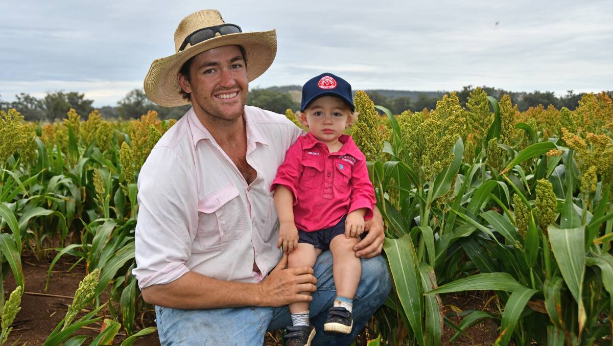 Somerton grower Will Chaffey and his son Freddy, 15 months, have taken on board harsh lessons from last season's sorghum harvest. Photo: Billy Jupp