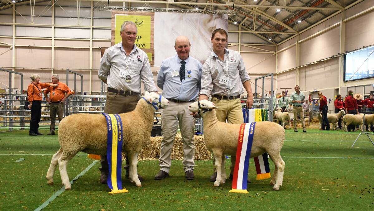 The grand and reserve champion Rocdell ewes with stud principals Brett and Cameron Picker, presented by judge Michael Wall. 