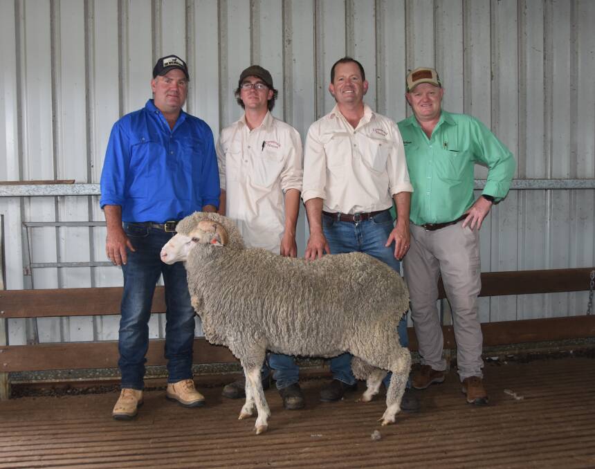 Top buyer Tom Schaefer, Guyra, with Angus and Lach Fulloon, Cressbrook, alongside auctioneer John Settree, Nutrien.