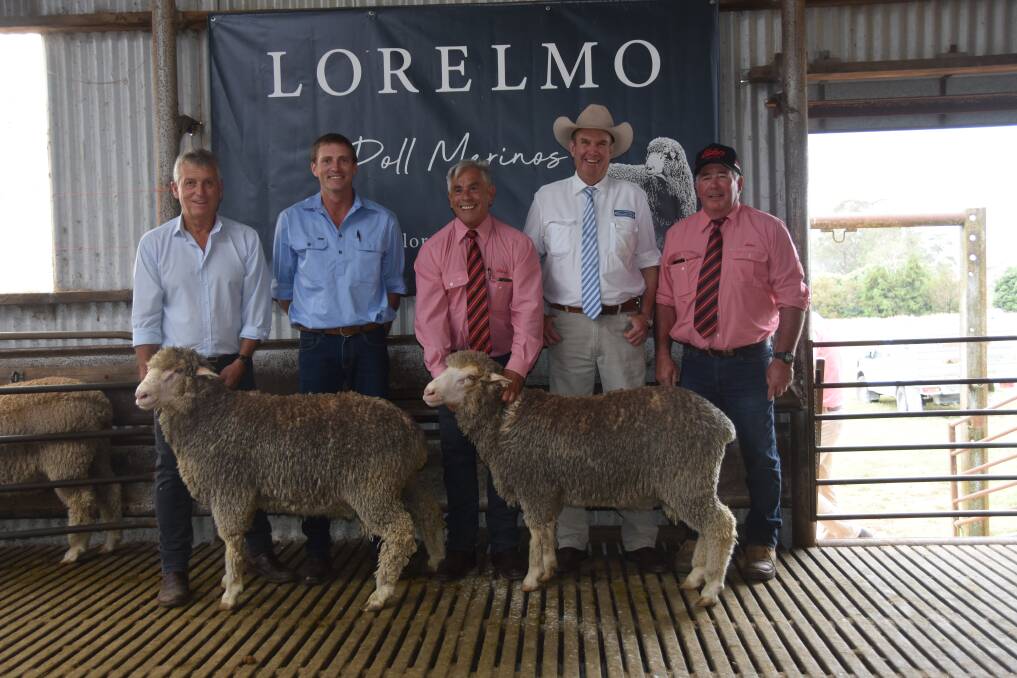 Bill Walker, vendor Ed Cordingley, Tom Henry and Allan Laurie from Elders Walcha and auctioneer Paul Dooley with the top and second top-priced rams.