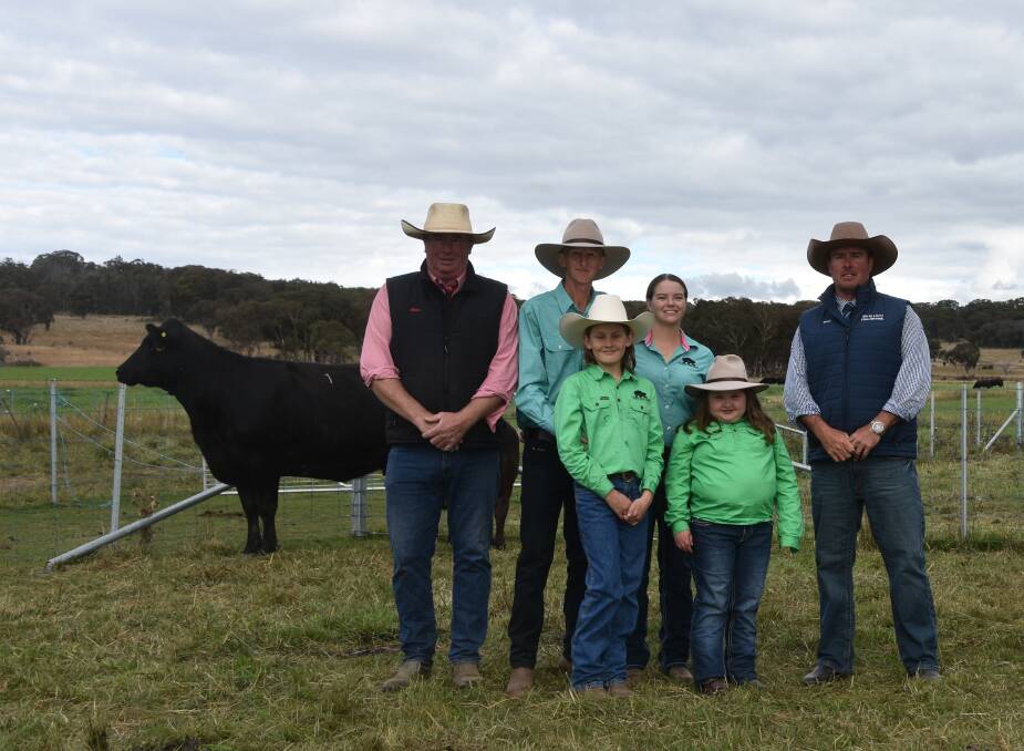 Mark Aitkin, Elders, with Jason, Jack and Grace Sidell and Laura Penrose from Figtree Park Angus and auctioneer Shad Bailey, Colin Say and Co, Glen Innes.