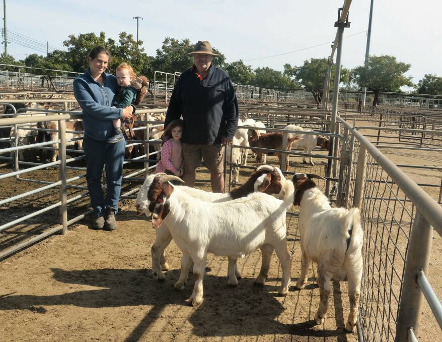 A pen of three Boer bucks sold for $480 per head, with sucessful purchasers Tiffany, Oliver (one), Charlotte (three), and Brett Mill, Murga, near Eugowra. Photo: Kate Loudon